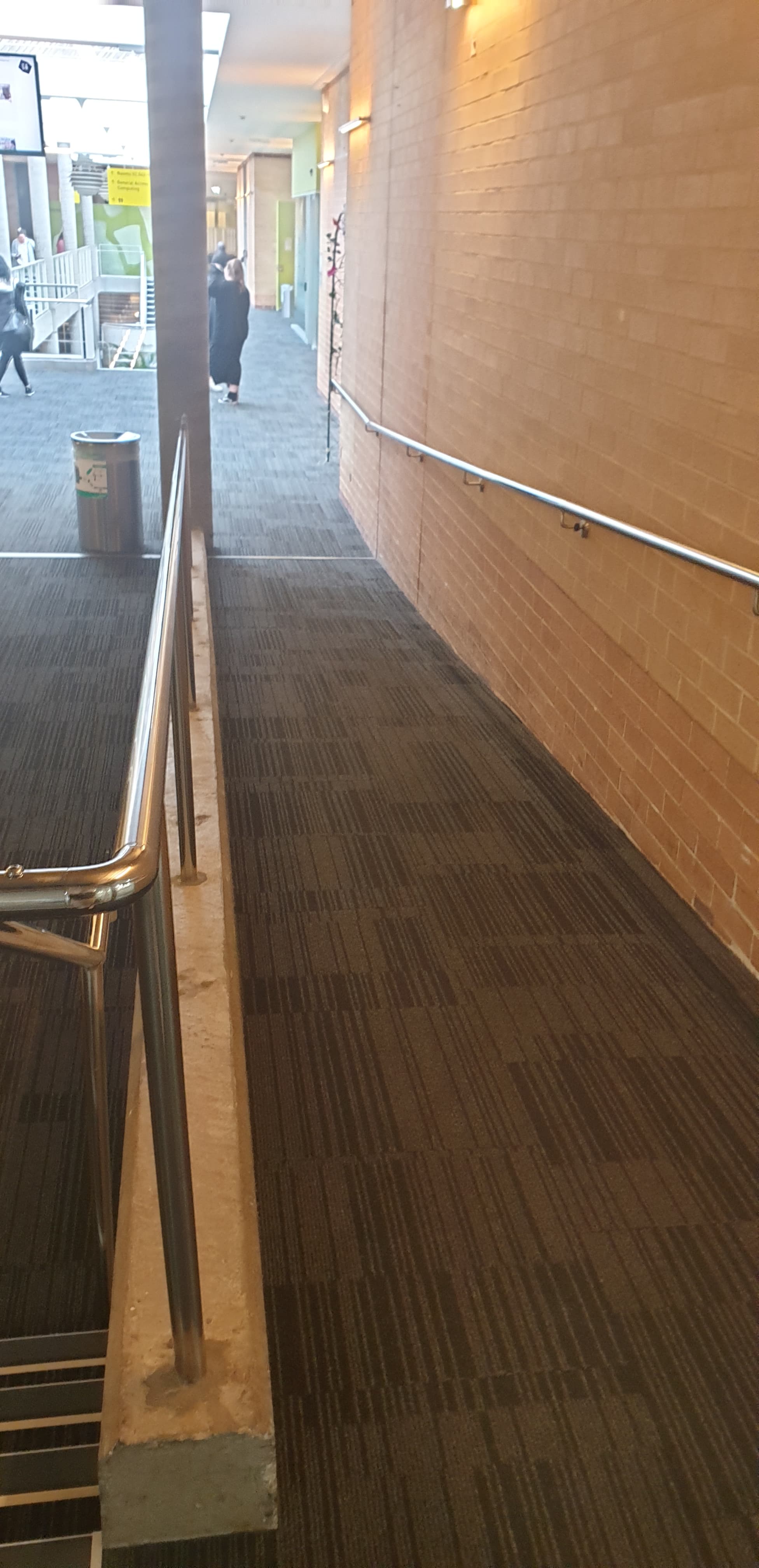 A wheelchair ramp next to a set of stairs.